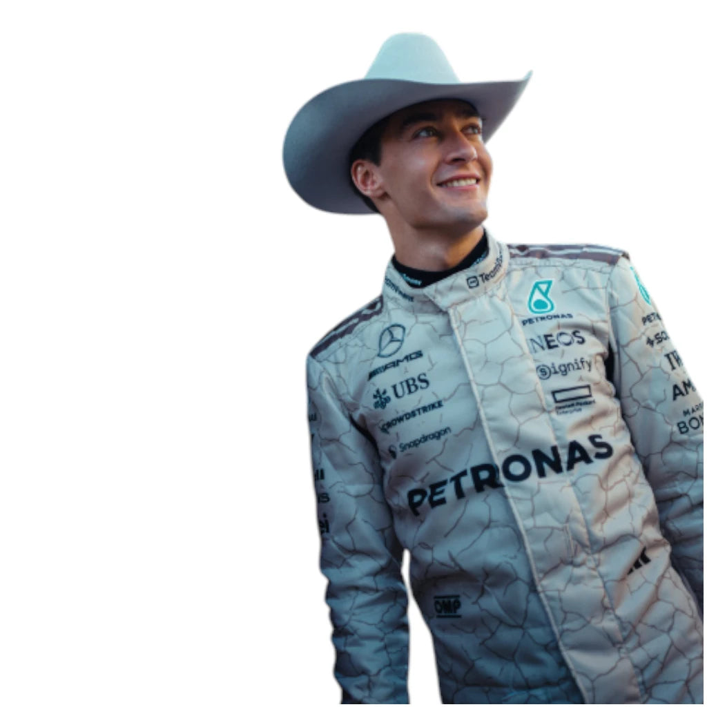Person wearing a racing suit with Petronas branding and a cowboy hat.