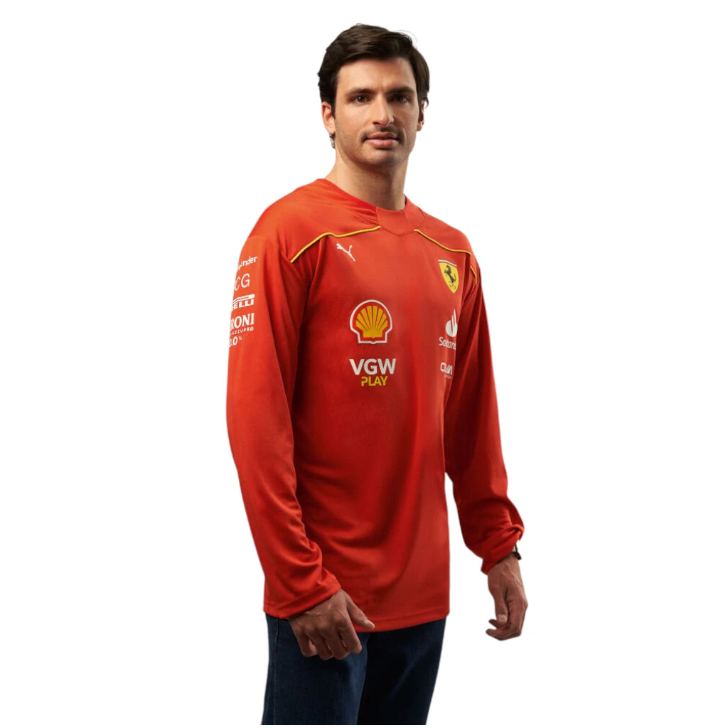 Man wearing a red sports jersey with various logos on a white background