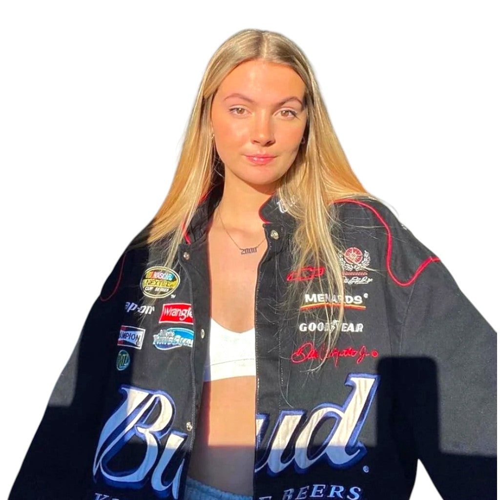 Person wearing a jacket with multiple brand logos on a white background