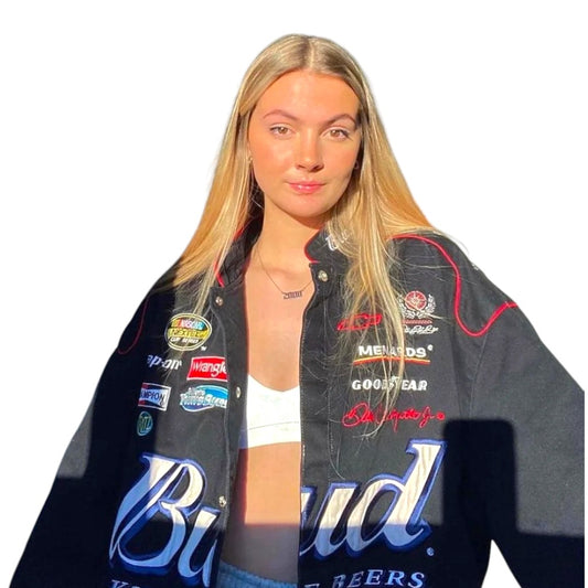 Person wearing a jacket with multiple brand logos on a white background