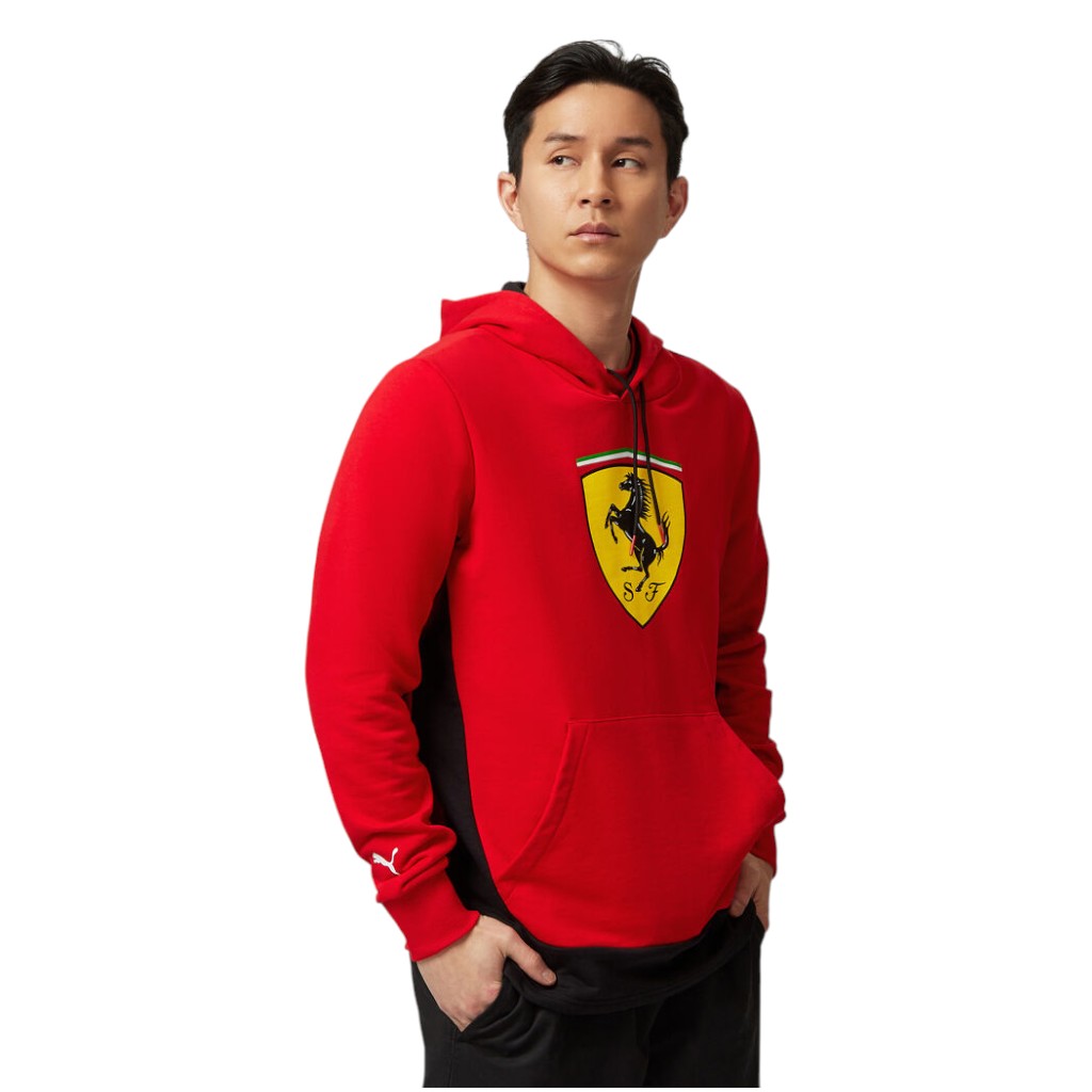 Person wearing a red Ferrari hoodie on a white background