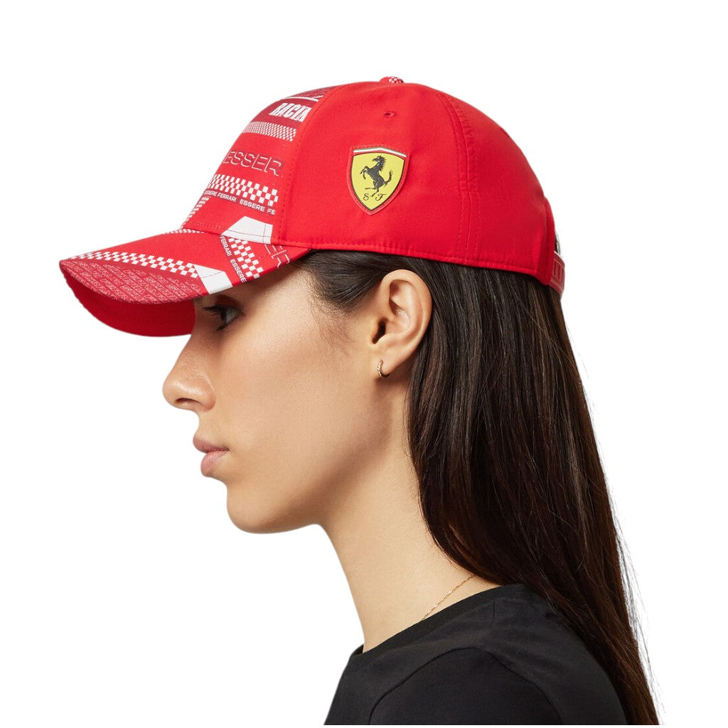 Red cap with Ferrari logo worn by a person on a white background