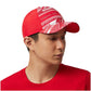 Person wearing a red cap with white patterns on a white background