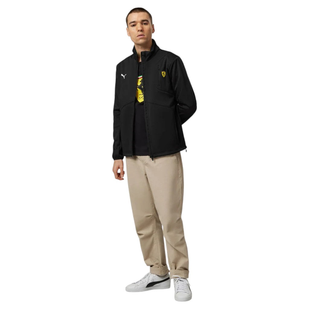 Person wearing a black jacket with a logo, beige pants, and white shoes on a white background