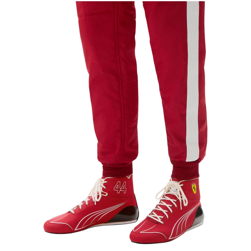 Red tracksuit with white stripes and matching red shoes on a white background