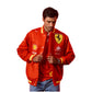 Man wearing a red jacket with various logos on a white background