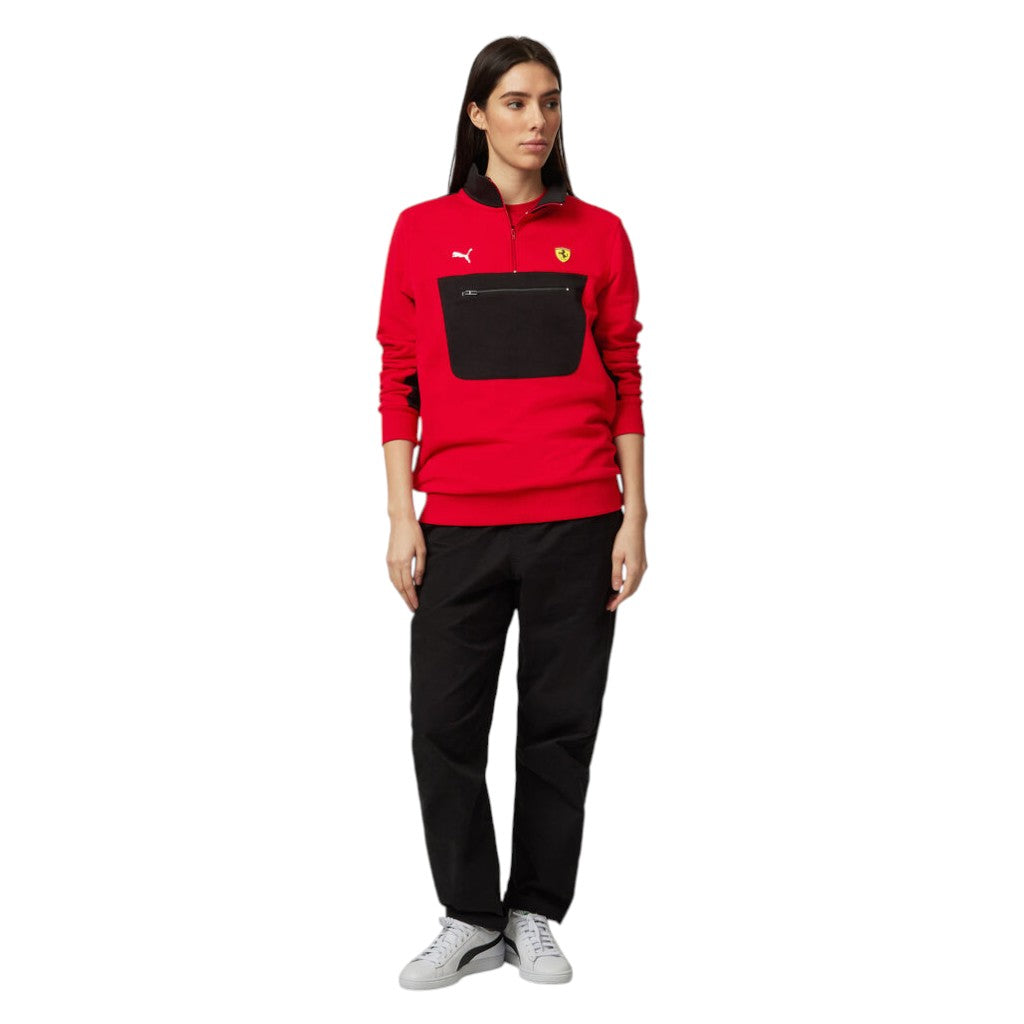 Person wearing a red and black tracksuit with a logo on a white background