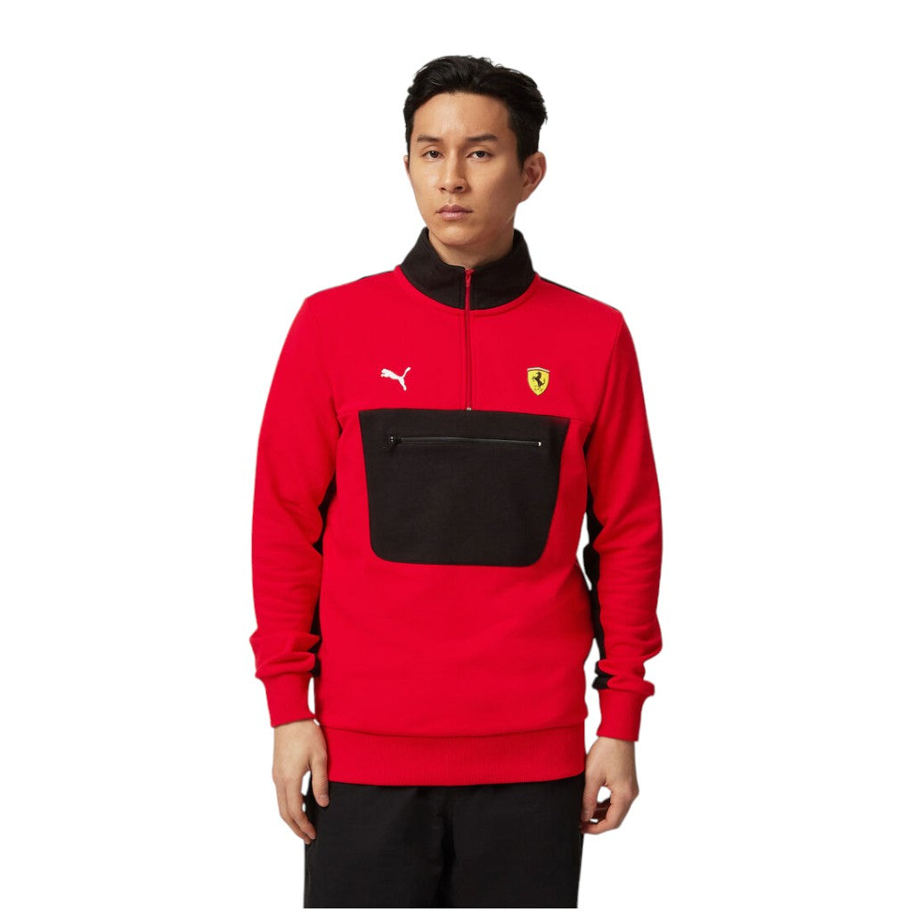 Person wearing a red and black sports jacket with a logo on a white background