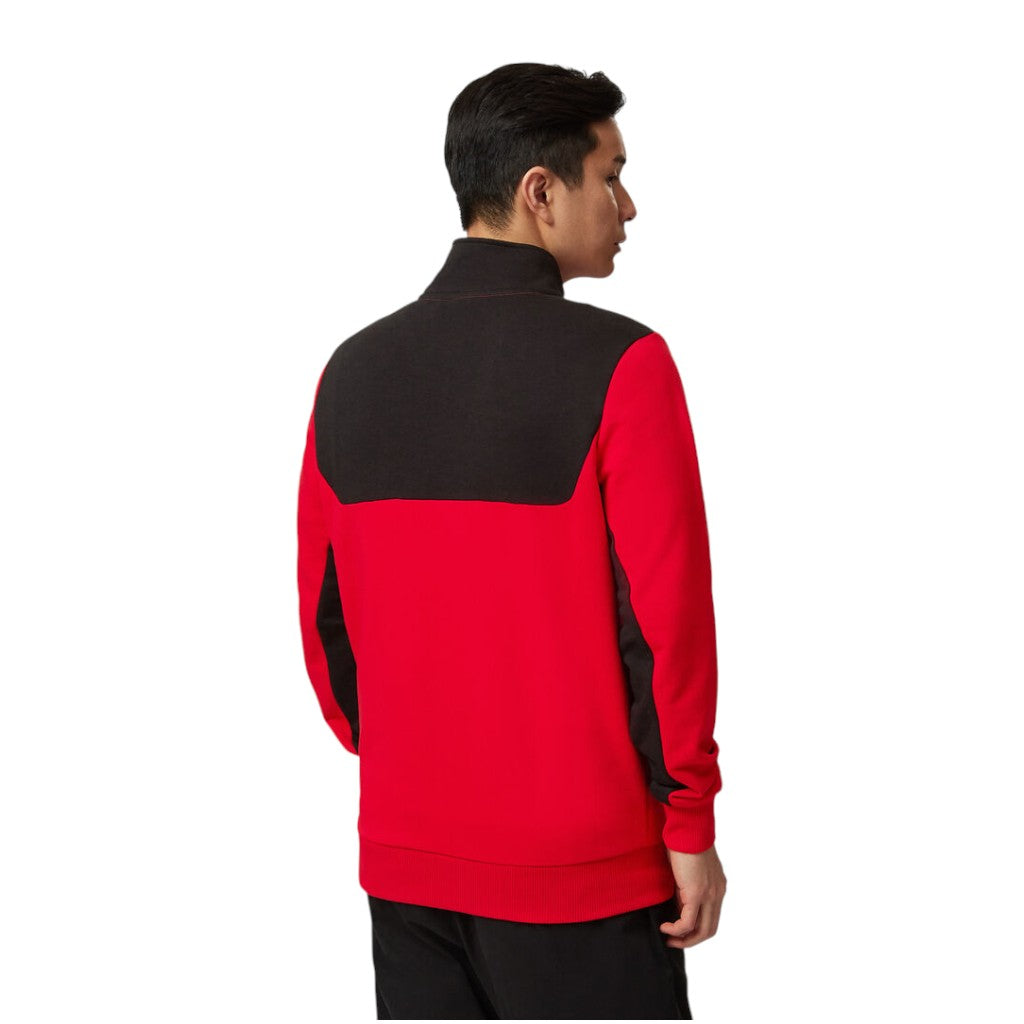 Person wearing a red and black jacket on a white background