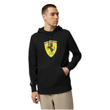 Person wearing a black Ferrari hoodie on a white background