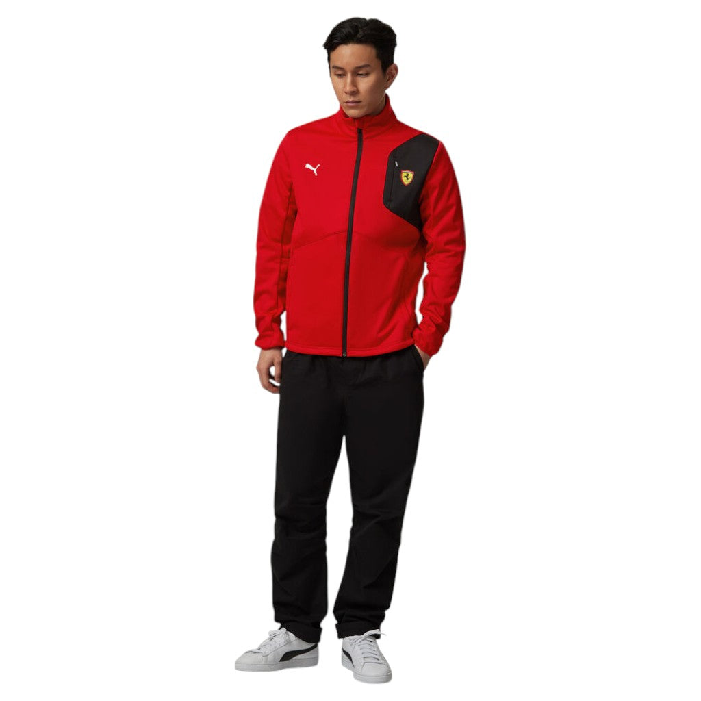 Person wearing a red and black tracksuit with a logo on a white background