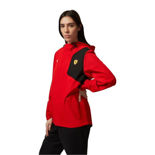 Person wearing a red and black jacket with a logo on a white background