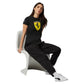 Woman wearing a black Ferrari t-shirt and pants sitting on a white chair.