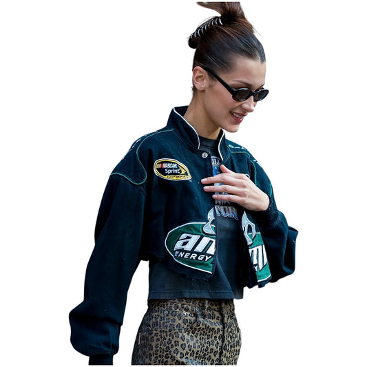 Person wearing a dark blue jacket with logos on a white background