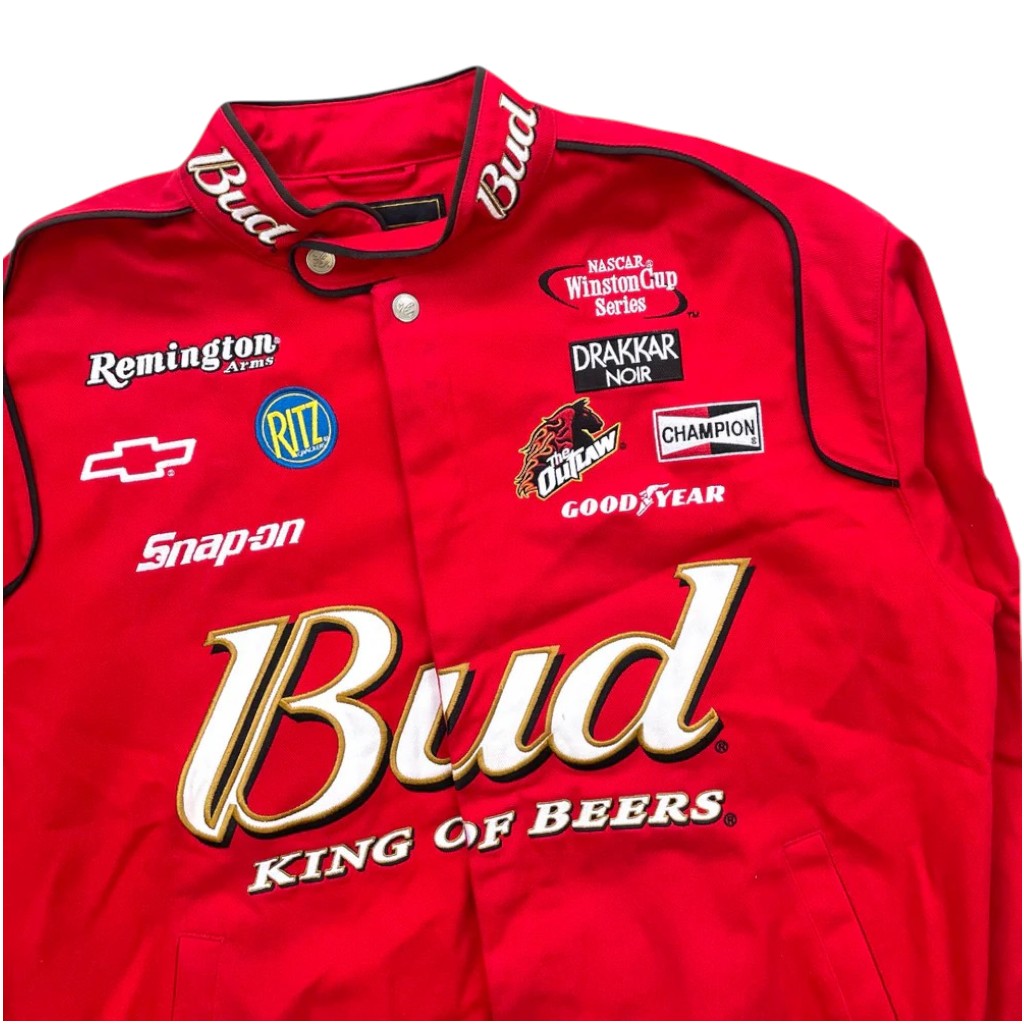 Red racing jacket with various sponsor logos on a white background
