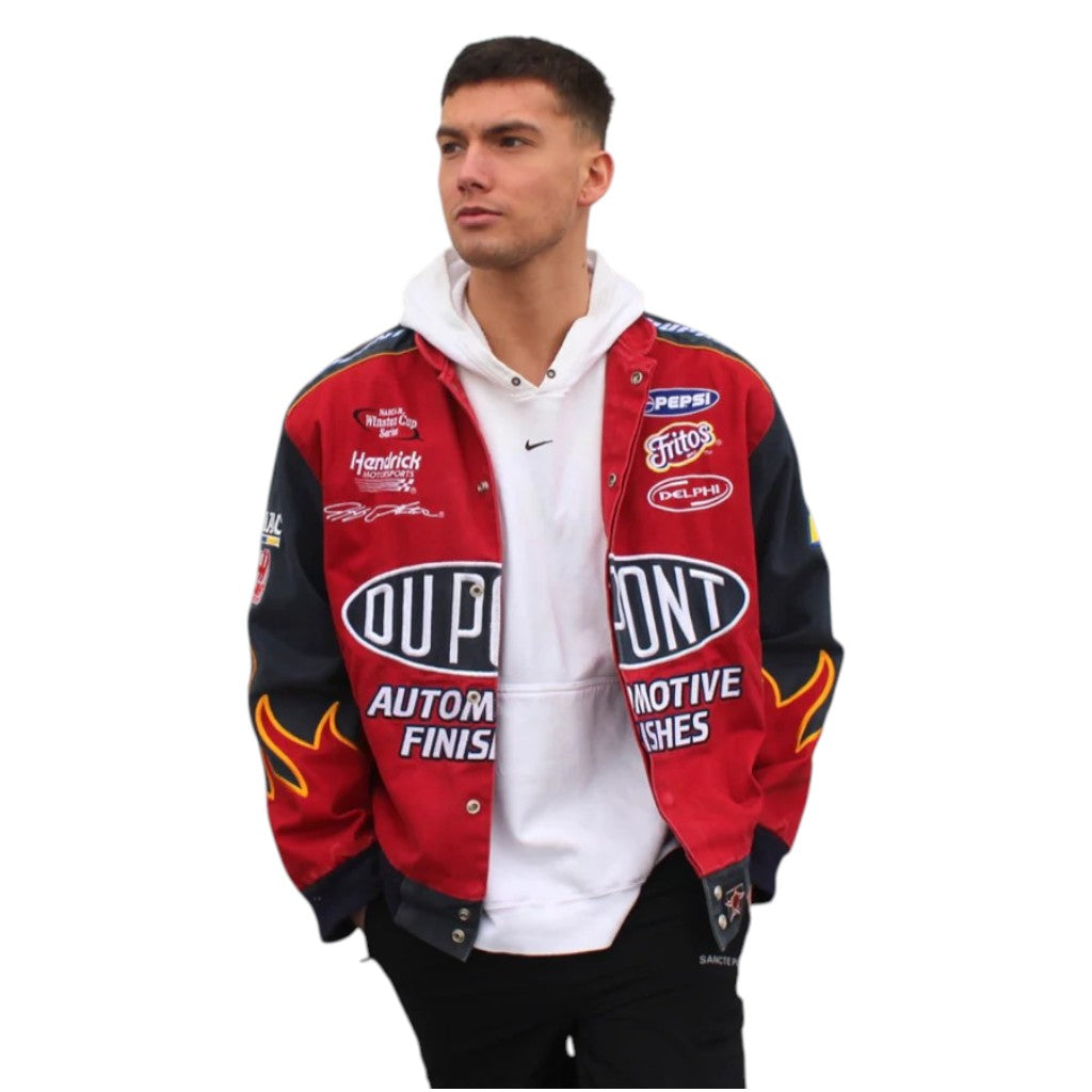 Man wearing a red and black jacket with various sponsor logos on a white background