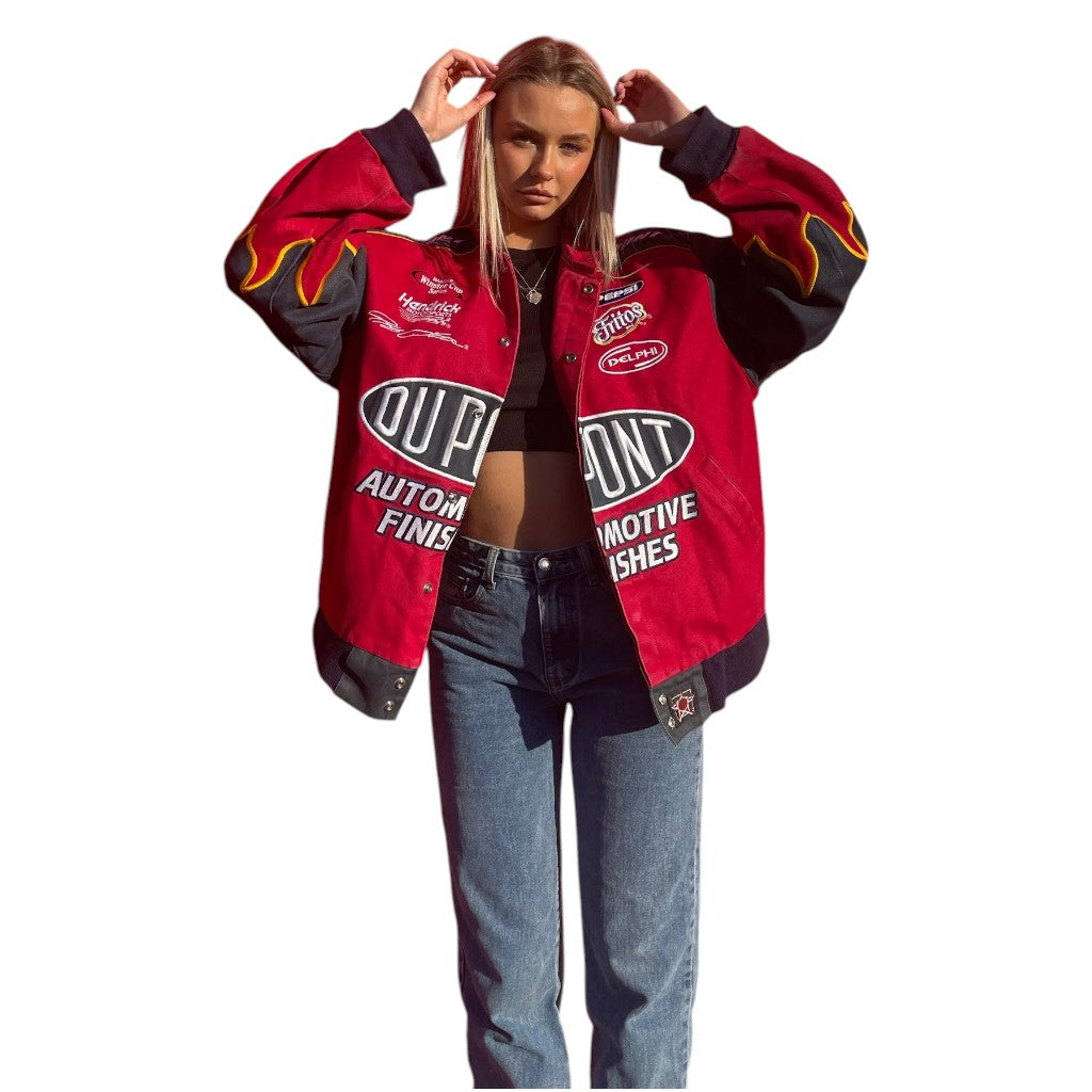 Person wearing a red and black jacket with branding on a white background