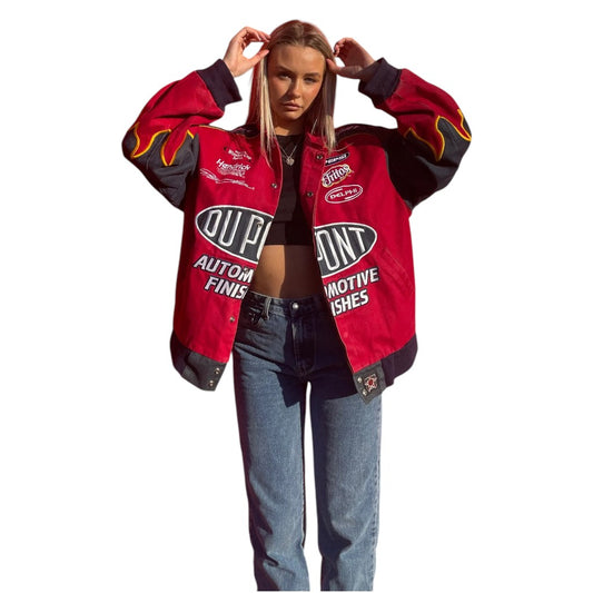 Person wearing a red and black jacket with branding on a white background