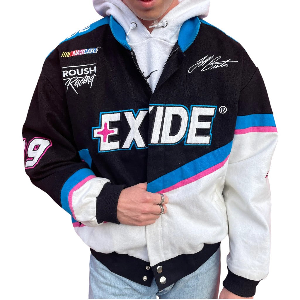 Person wearing a black and white jacket with Exide logo and branding on a white background