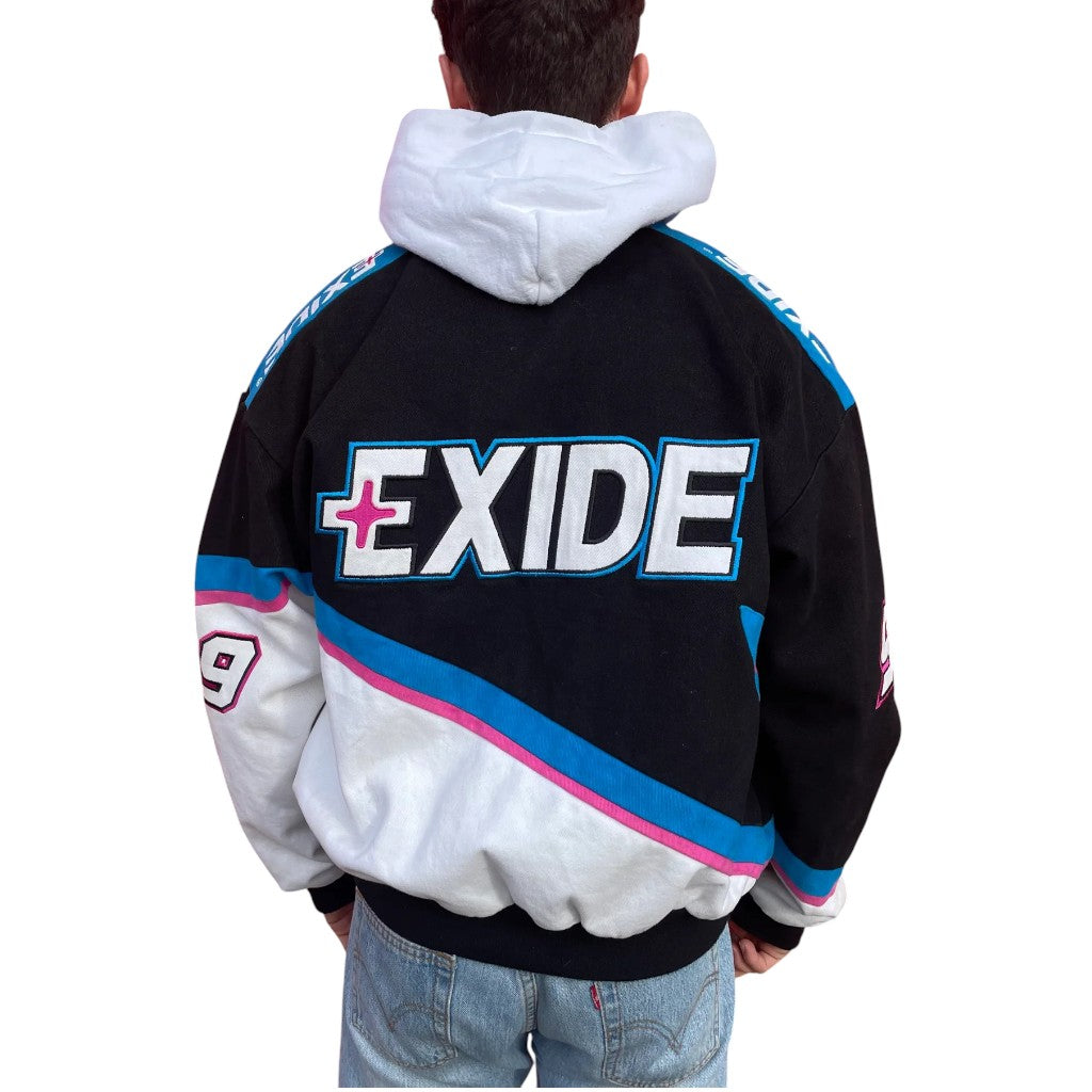 Black and white jacket with Exide logo on the back, worn by a person.