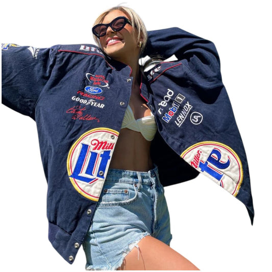 Person wearing a navy blue jacket with multiple brand logos on a white background