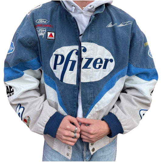 Blue and white racing jacket with various sponsor logos, including Pfizer, on a white background.