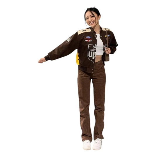 Woman wearing a brown jacket with logos and brown pants on a white background