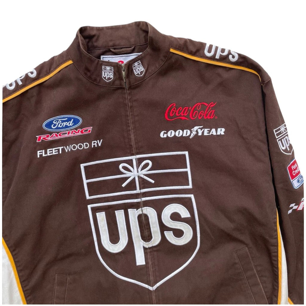 Brown racing jacket with various logos including UPS, Ford, Coca-Cola, and Goodyear on a white background.