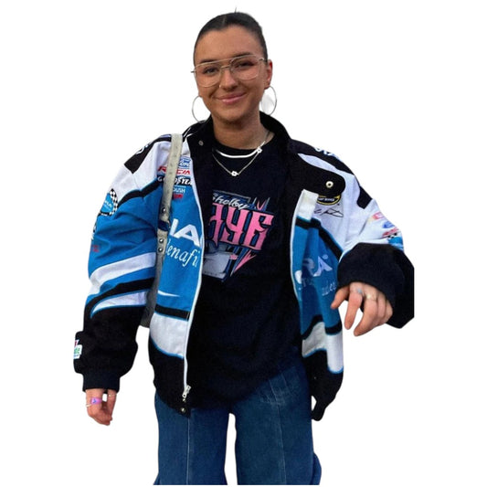 Person wearing a colorful jacket with various logos on a white background