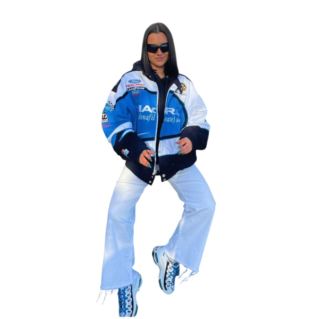 Person wearing a blue and white jacket with various logos on a white background